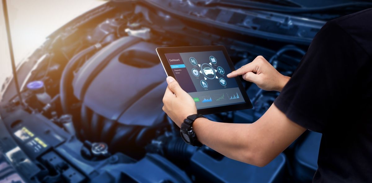 Technician performing OBD-II emissions test